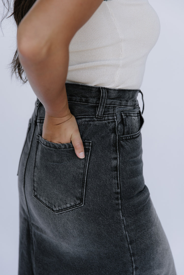 Girl wearing dark denim skirt