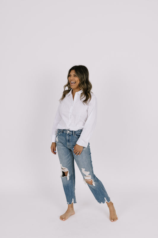 Girl wearing white button up with open back