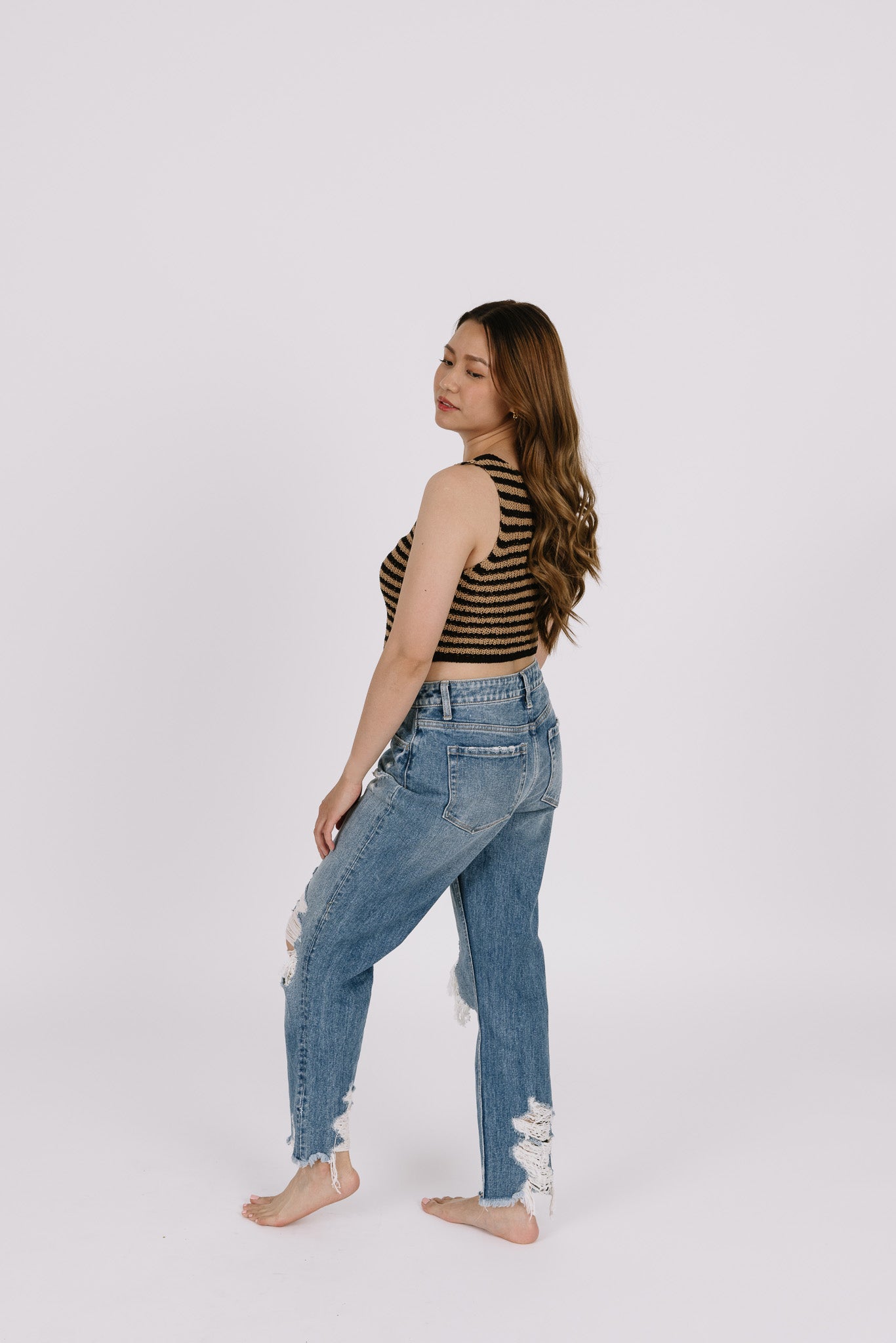 Girl wearing tan and black striped top